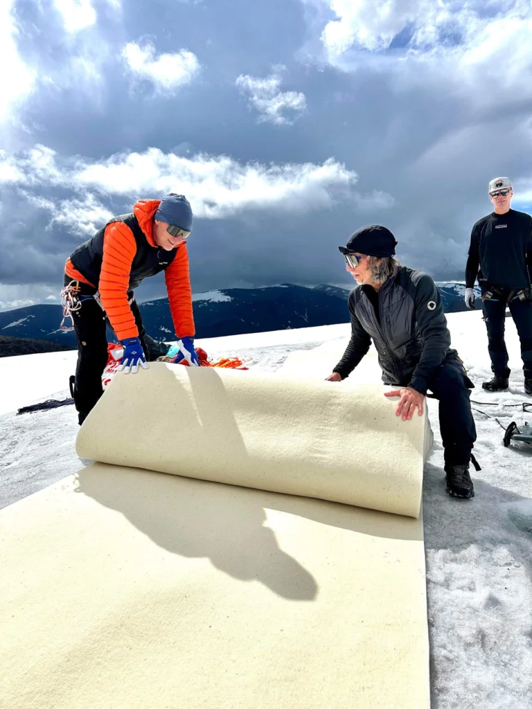 Glacier blanket crew rolling out wool on the ice, from the project Oskar Kihlborg leads