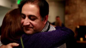 Iman Aghay in an embrace, a still from the One Good Story Project film A Second Chance at Life.