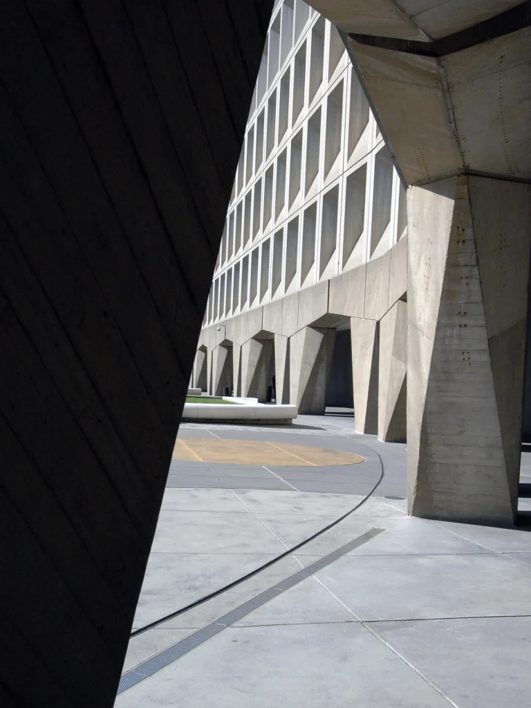 The curved concrete front of the Robert C. Weaver Federal Building, headquarters of the U.S. Department of Housing and Urban Development in Washington, D.C. This is an illustration of where Ann Oliva worked for 10 years, not a photograph of her.
